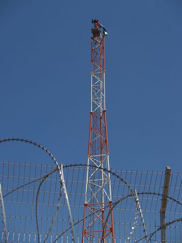 Click on image to see full-sized version Tito on the top of military tower hanging Palestinian flag