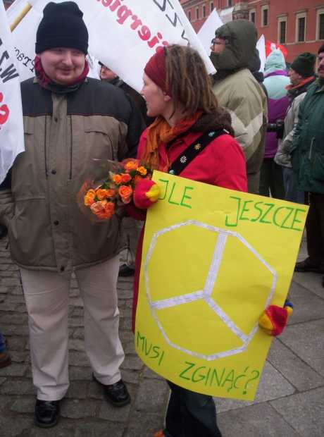 Dorota with Peace Sign with Names of victims ('How many more have to die?') & PHO Global Education Co-ordinator Marcin